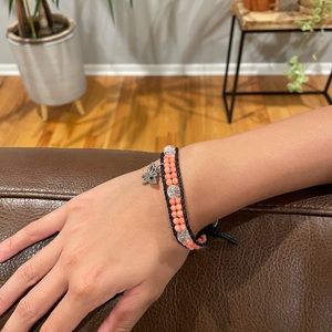 Beaded bracelet with butterfly charm. Lightweight. Coral/pink beads and clear